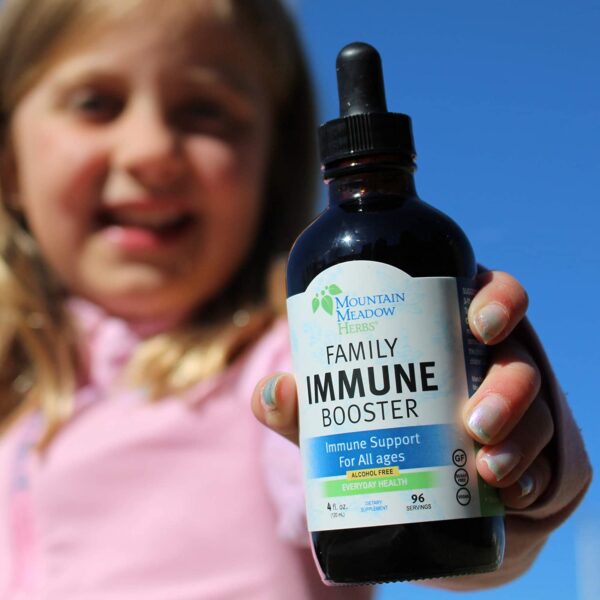 girl holding bottle of immune booster supplement
